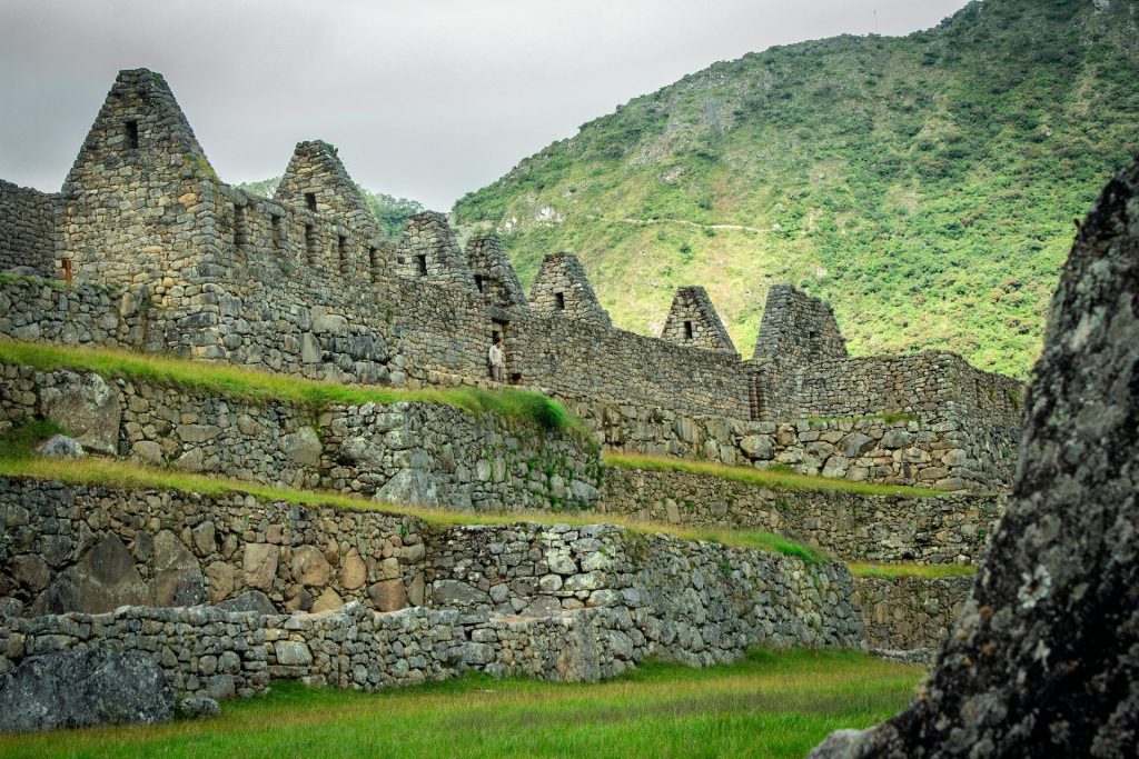 Explore the ancient stone ruins of Machu Picchu against a lush mountain backdrop.