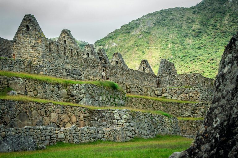 Explore the ancient stone ruins of Machu Picchu against a lush mountain backdrop.