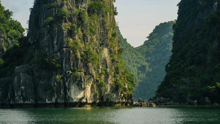 Breathtaking view of dramatic limestone cliffs and emerald waters in Halong Bay, Vietnam.