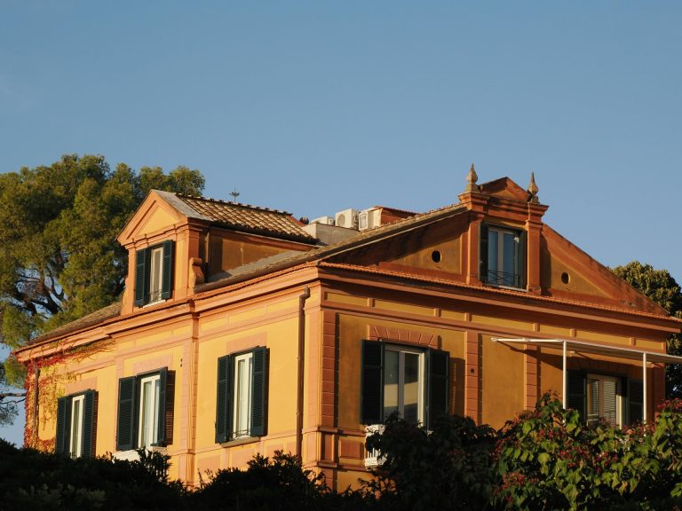 Charming Mediterranean villa in Positano, Italy features vibrant architecture under a clear sky.