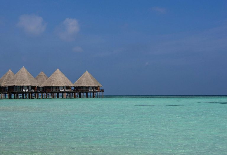 Stunning view of tropical overwater bungalows amidst clear turquoise waters in the Maldives.