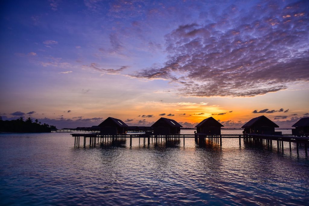 Overwater honeymoon villa above turquoise water