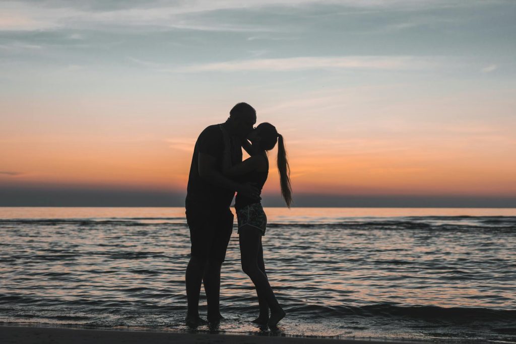 Newlywed couple on a beach at sunset