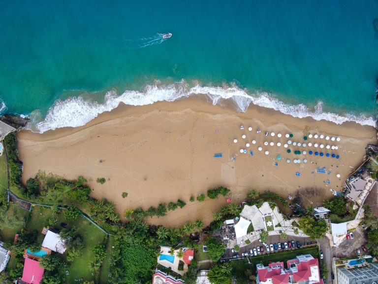 Stunning aerial shot of Sosúa Beach, Puerto Plata, showcasing crystal waters and sandy shores.