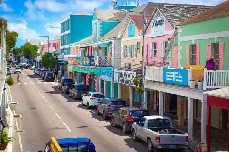 Colorful shops and local life on a sunny street in Nassau, Bahamas.