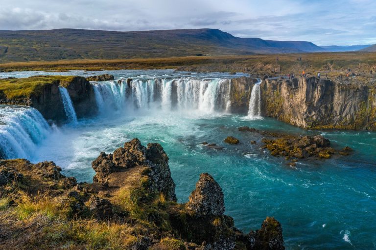 Godafoss Waterfall cascading beautifully amidst rocky terrain, showcasing Iceland's breathtaking natural scenery.
