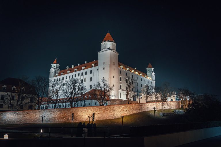 Stunning night view of the illuminated Bratislava Castle in Slovakia, showcasing its majestic architecture.