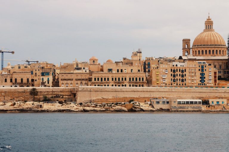 Explore Valletta's historic architecture and Mediterranean charm from a serene waterfront view.