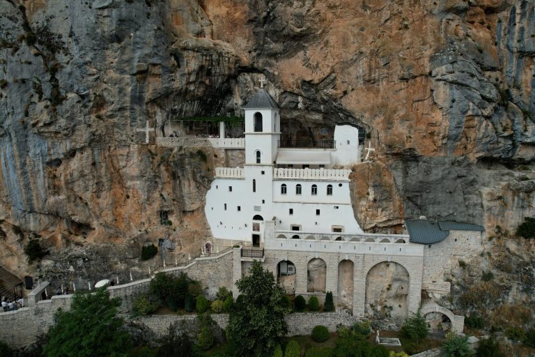 A breathtaking view of Ostrog Monastery built into the cliffside, showing its unique architecture.