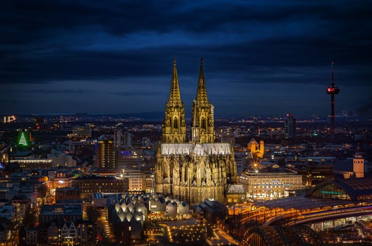Stunning night shot of Cologne Cathedral and cityscape, beautifully illuminated.