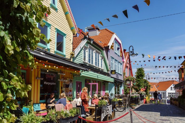 Vibrant street view of colorful houses and cafes in Stavanger, Norway.