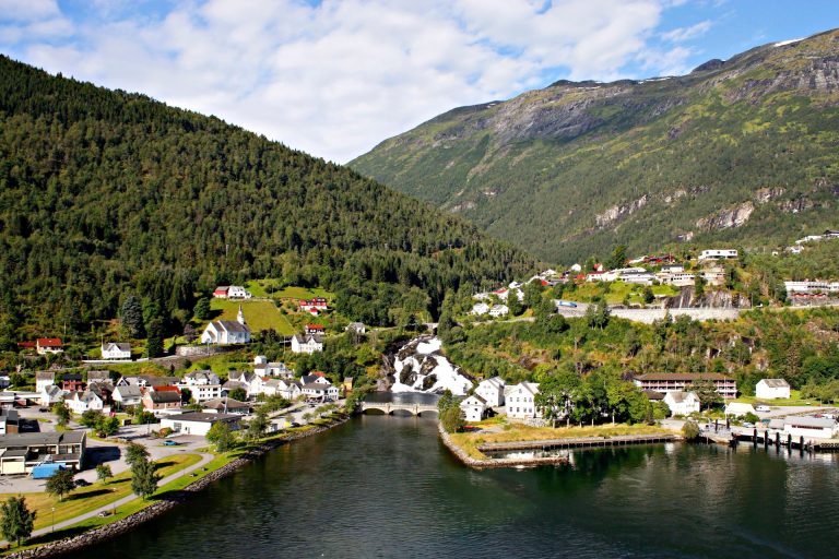 A breathtaking view of the picturesque town of Hellesylt nestled in Norway's stunning fjords.