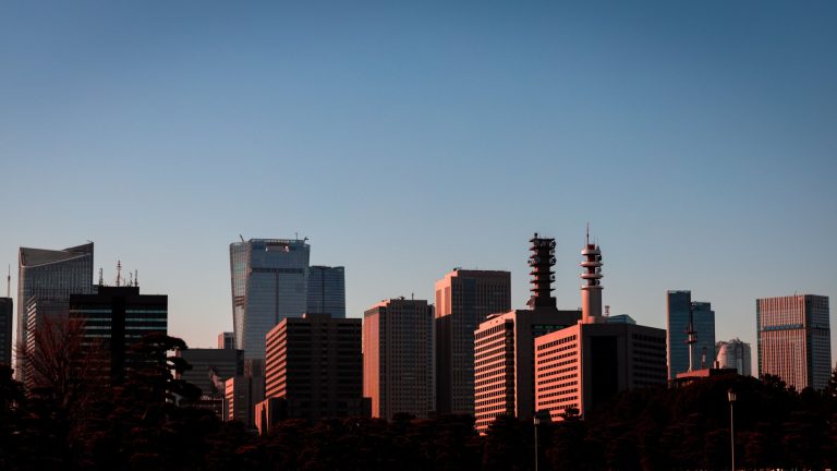Sunset view of Tokyo skyline showcasing modern skyscrapers and urban architecture.