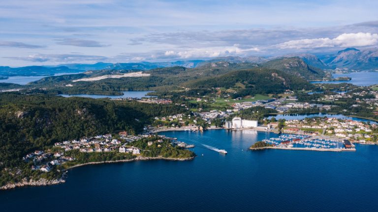 Stunning aerial view of Stavanger, Norway showcasing the coastline, harbor, and surrounding mountains.