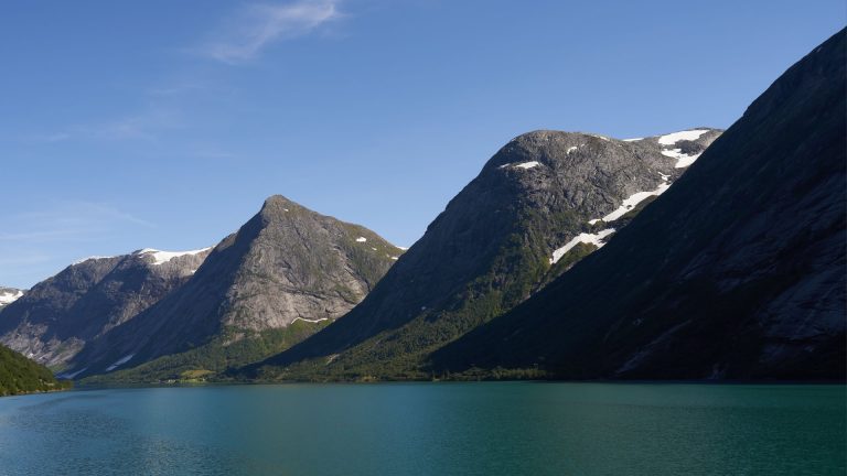 A stunning mountain and lake scene with clear blue skies and snow-capped peaks, perfect for nature lovers.