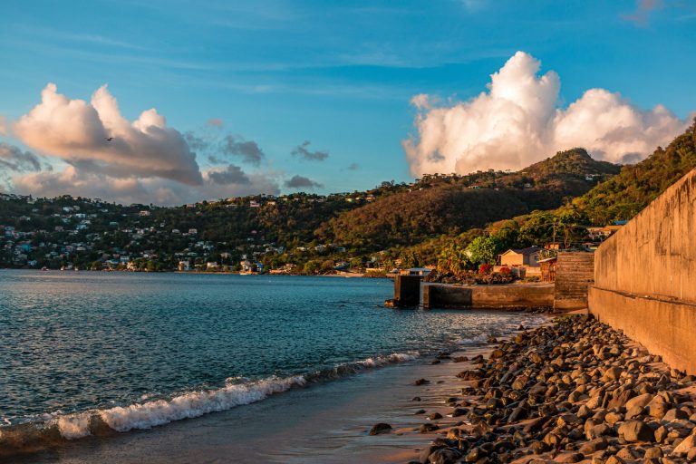 Beautiful coastal town with hills and cloudy sky, perfect travel spot.