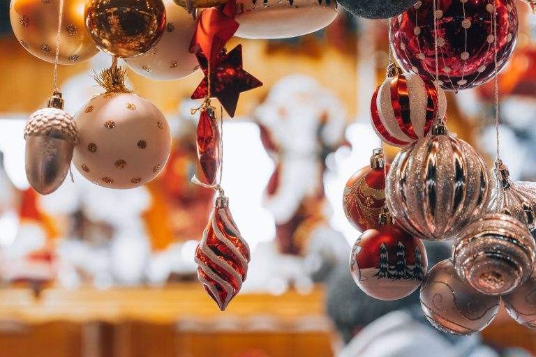 Colorful Christmas ornaments hanging in a store, capturing the festive winter season.