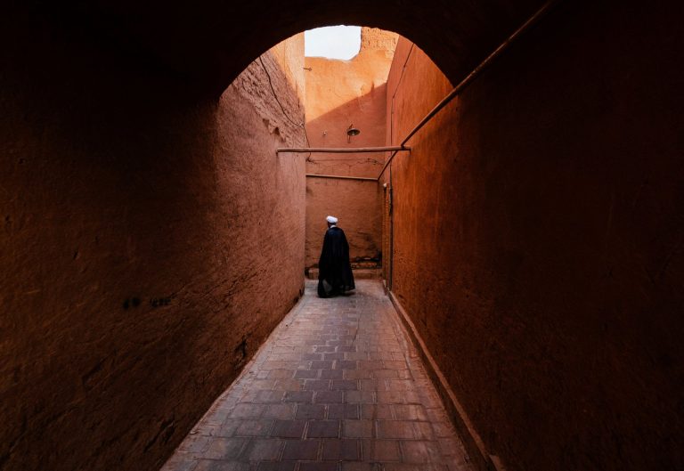 Explore the historic alleys of Yazd, Iran, with traditional architecture and serene ambiance.